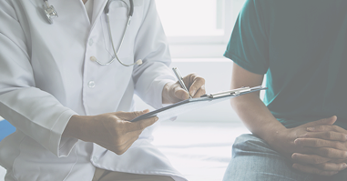 Doctor signing paperwork